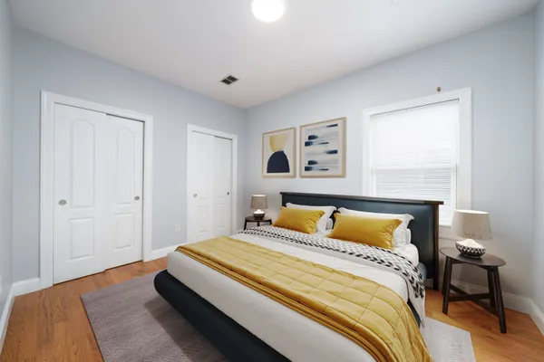 a bedroom with a bed and a painting on the wall