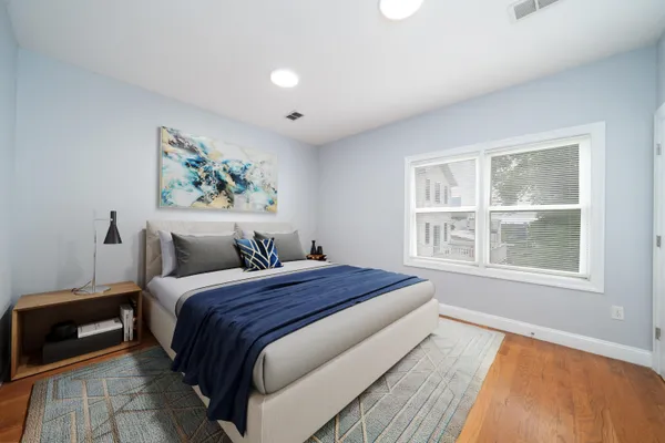 a bedroom with bed and a window