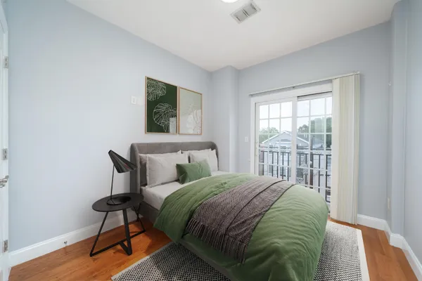 a bedroom with a bed a lamp and a window