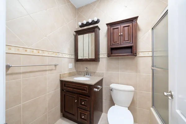 a bathroom with a toilet sink and mirror