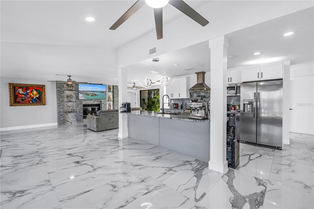 583 Crystal Drive Madeira Beach, FL 33708 - Photo 19 of 100 a kitchen with stainless steel appliances granite countertop a refrigerator and a sink