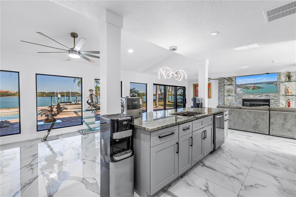 583 Crystal Drive Madeira Beach, FL 33708 - Photo 22 of 100 a kitchen with stainless steel appliances granite countertop a sink and cabinets