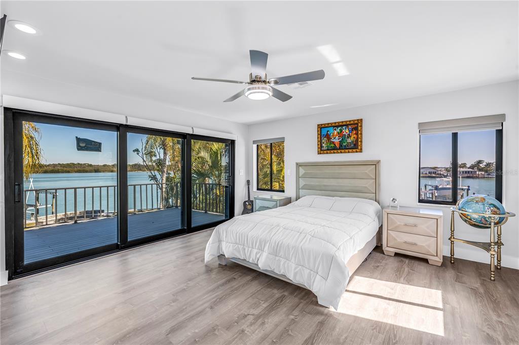 583 Crystal Drive Madeira Beach, FL 33708 - Photo 48 of 100 a spacious bedroom with a large bed and a large window