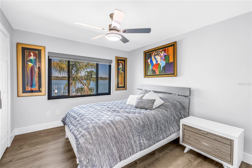 583 Crystal Drive Madeira Beach, FL 33708 - Photo 59 of 100 a bedroom with a large bed and a window