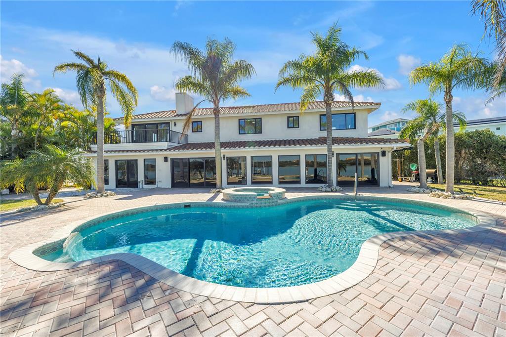 583 Crystal Drive Madeira Beach, FL 33708 - Photo 80 of 100 a front view of a house with a yard table and chairs
