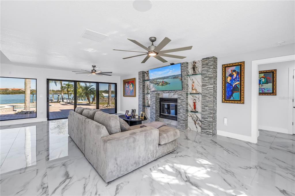 583 Crystal Drive Madeira Beach, FL 33708 - Photo 8 of 100 a living room with furniture a large window and a fireplace