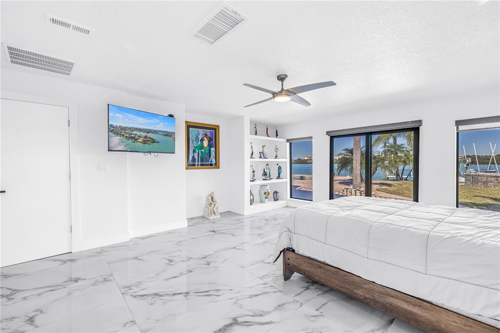 583 Crystal Drive Madeira Beach, FL 33708 - Photo 10 of 100 a spacious bedroom with a large bed and a large window