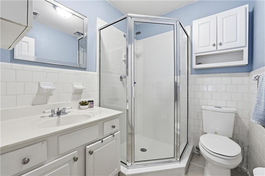1101 Collier Road Northwest, Unit Q6 Atlanta, GA 30318 - Photo 11 of 20 a bathroom with a sink toilet and shower