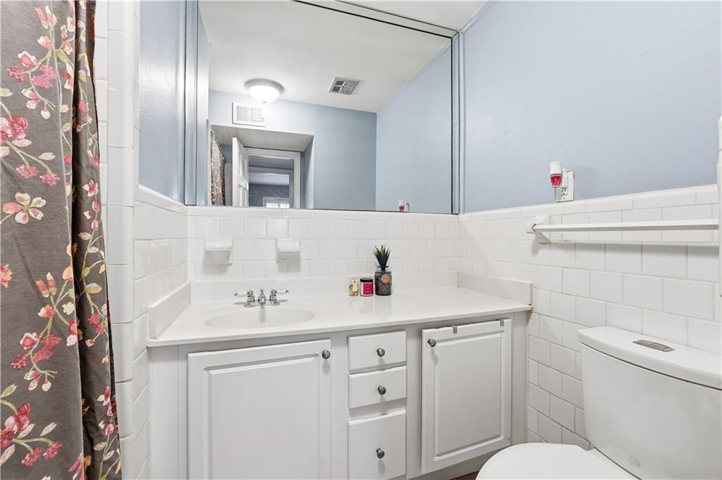 1101 Collier Road Northwest, Unit Q6 Atlanta, GA 30318 - Photo 13 of 20 a bathroom with a sink and a toilet