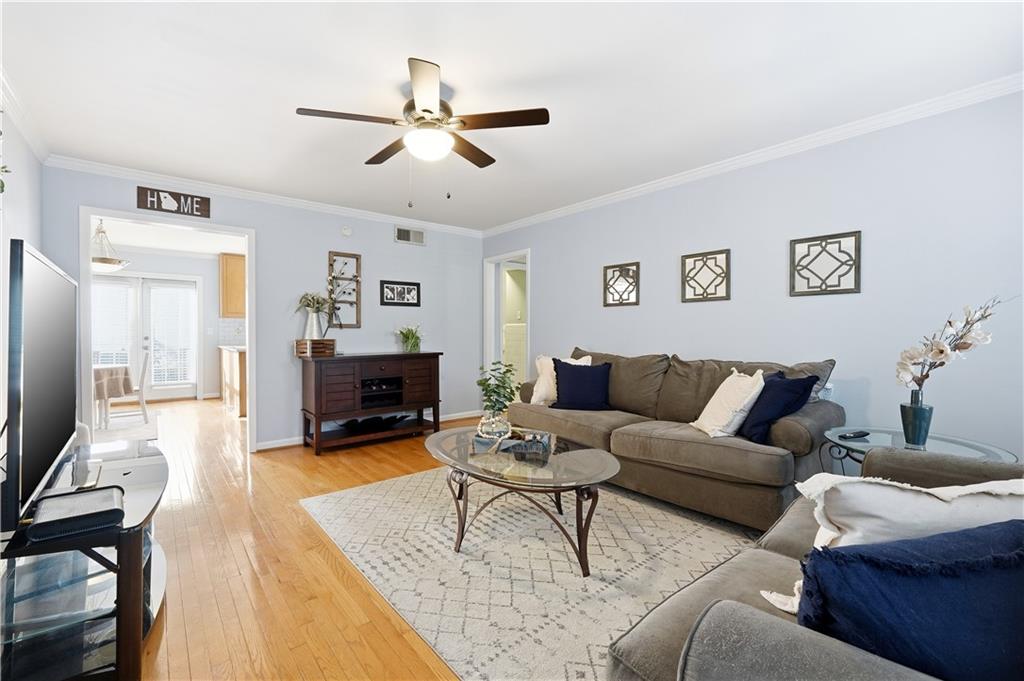 1101 Collier Road Northwest, Unit Q6 Atlanta, GA 30318 - Photo 3 of 20 a living room with furniture and a wooden floor