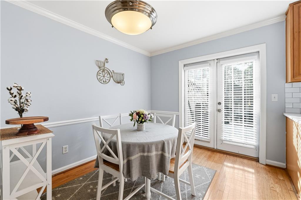 1101 Collier Road Northwest, Unit Q6 Atlanta, GA 30318 - Photo 7 of 20 a view of a dining room with furniture and wooden floor