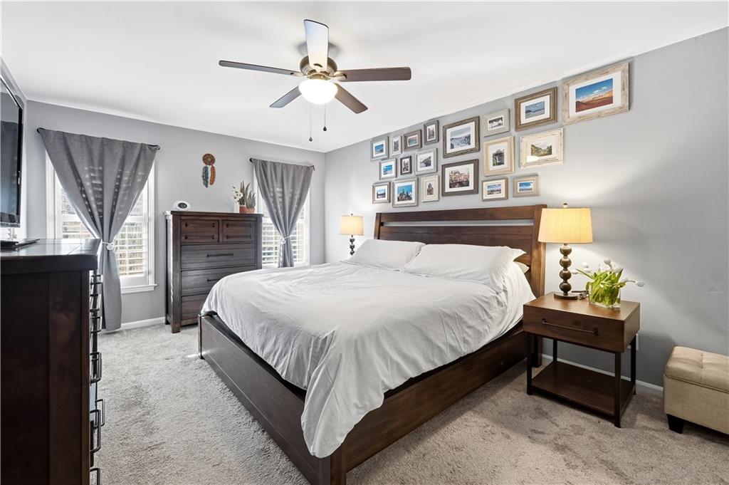 1101 Collier Road Northwest, Unit Q6 Atlanta, GA 30318 - Photo 8 of 20 a bedroom with a bed chandelier and a window