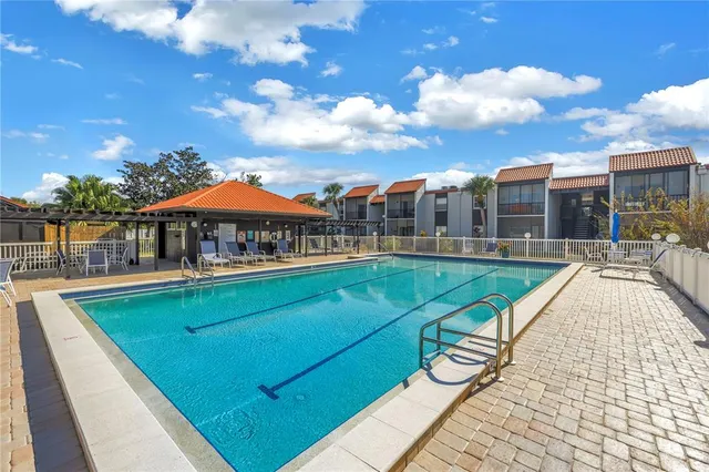 a view of swimming pool with a lounge chairs