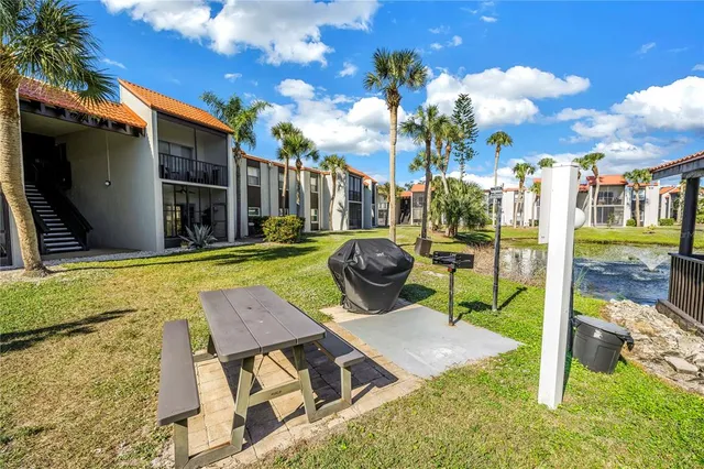 a view of a patio with couches table and chairs and potted plants