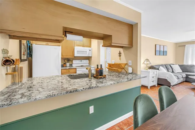 a living room with kitchen island furniture and a kitchen view