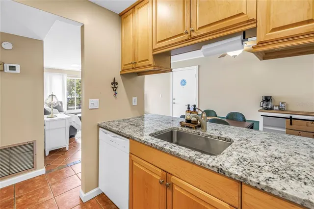 a kitchen with sink and cabinets
