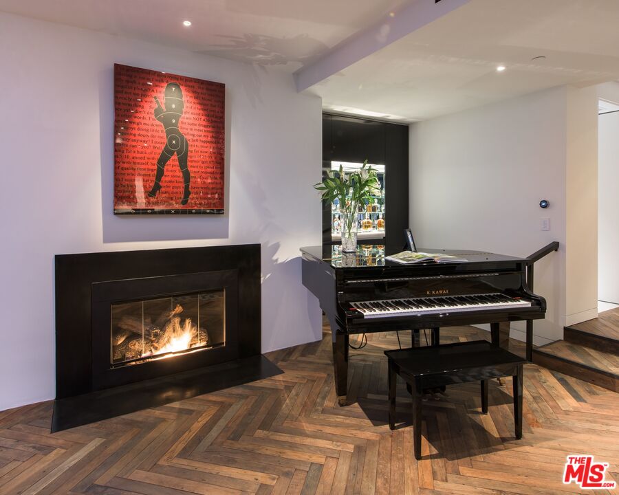 924 Palisades Beach Road Santa Monica, CA 90403 - Photo 11 of 54 a living room with a fireplace a rug and a fireplace