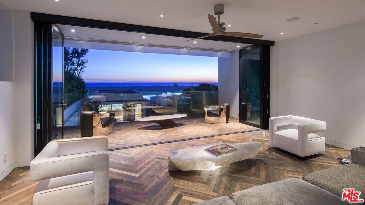 924 Palisades Beach Road Santa Monica, CA 90403 - Photo 14 of 54 a living room with furniture and a flat screen tv