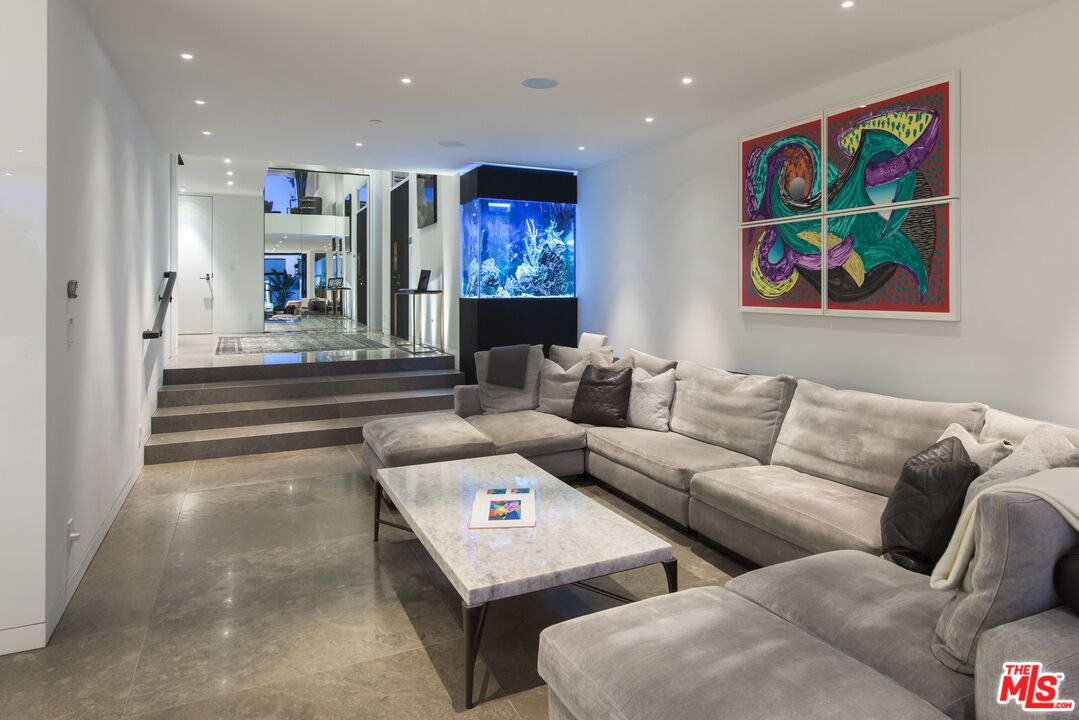 924 Palisades Beach Road Santa Monica, CA 90403 - Photo 19 of 54 a living room with furniture and a flat screen tv