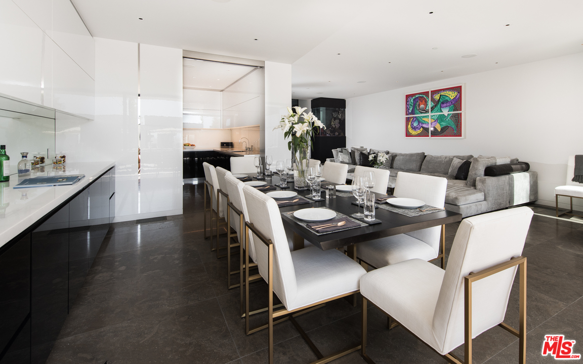 924 Palisades Beach Road Santa Monica, CA 90403 - Photo 23 of 54 a dining room with furniture a rug and wooden floor