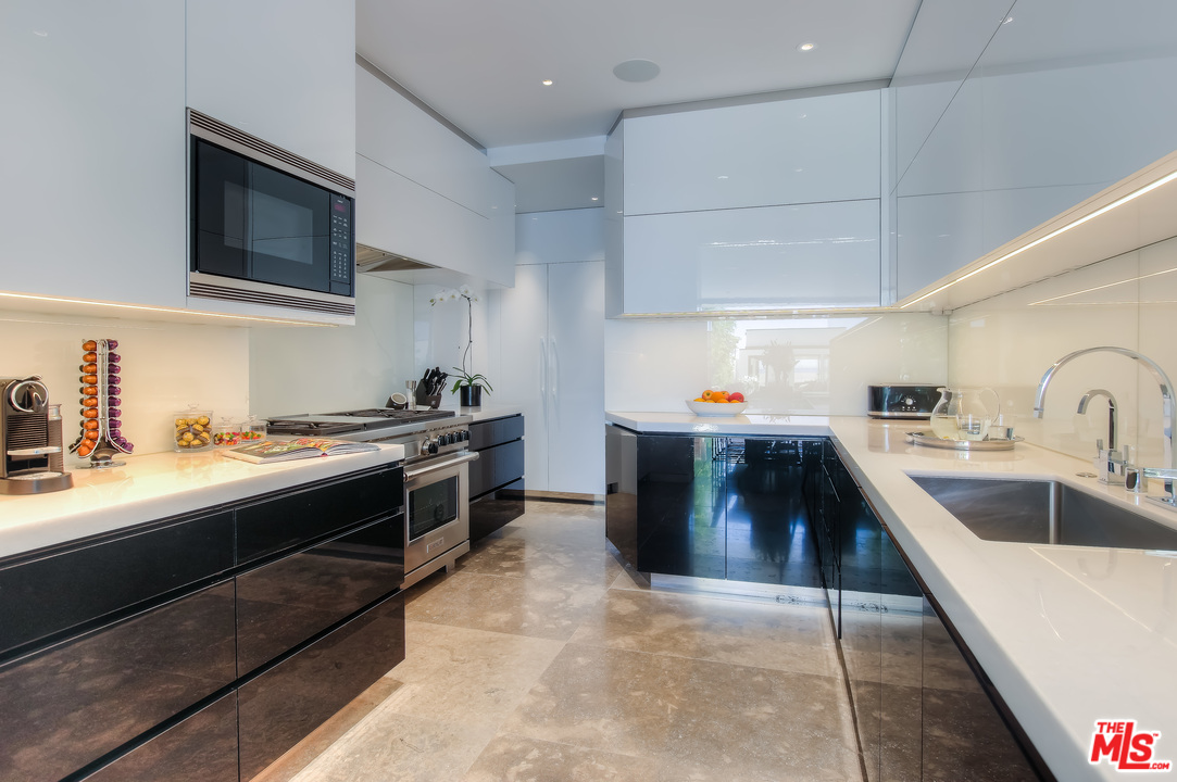 924 Palisades Beach Road Santa Monica, CA 90403 - Photo 25 of 54 a large kitchen with stainless steel appliances granite countertop a sink and a stove