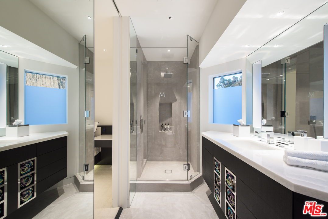 924 Palisades Beach Road Santa Monica, CA 90403 - Photo 27 of 54 a bathroom with a double vanity sink and mirror with shower