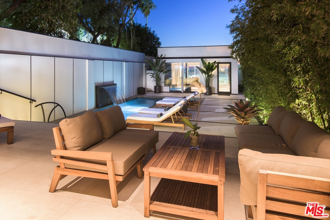 924 Palisades Beach Road Santa Monica, CA 90403 - Photo 35 of 54 a view of a patio with couches table and chairs and potted plants