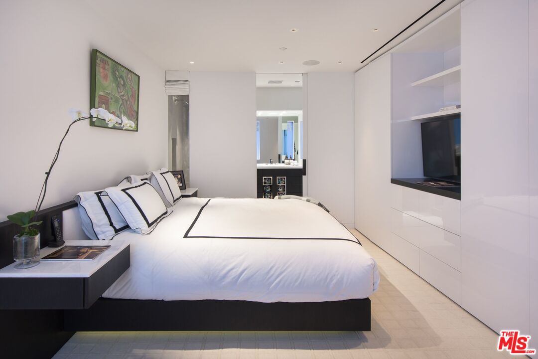 924 Palisades Beach Road Santa Monica, CA 90403 - Photo 44 of 54 a bedroom with a bed and a flat screen tv