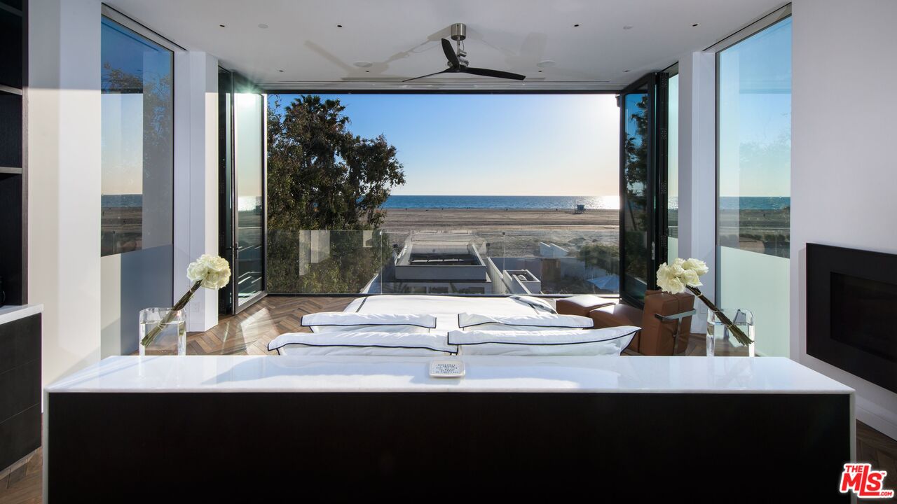 924 Palisades Beach Road Santa Monica, CA 90403 - Photo 48 of 54 a room with a large window and flat screen tv