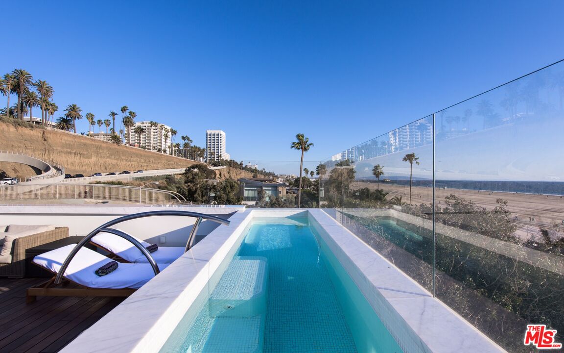 924 Palisades Beach Road Santa Monica, CA 90403 - Photo 49 of 54 a view of a swimming pool with a lounge chair