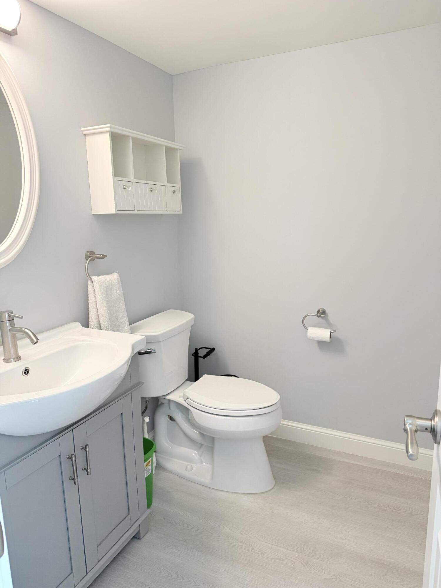 3450 South Ocean Boulevard, Unit 2220 Palm Beach, FL 33480 - Photo 12 of 36 a bathroom with a toilet a sink and mirror