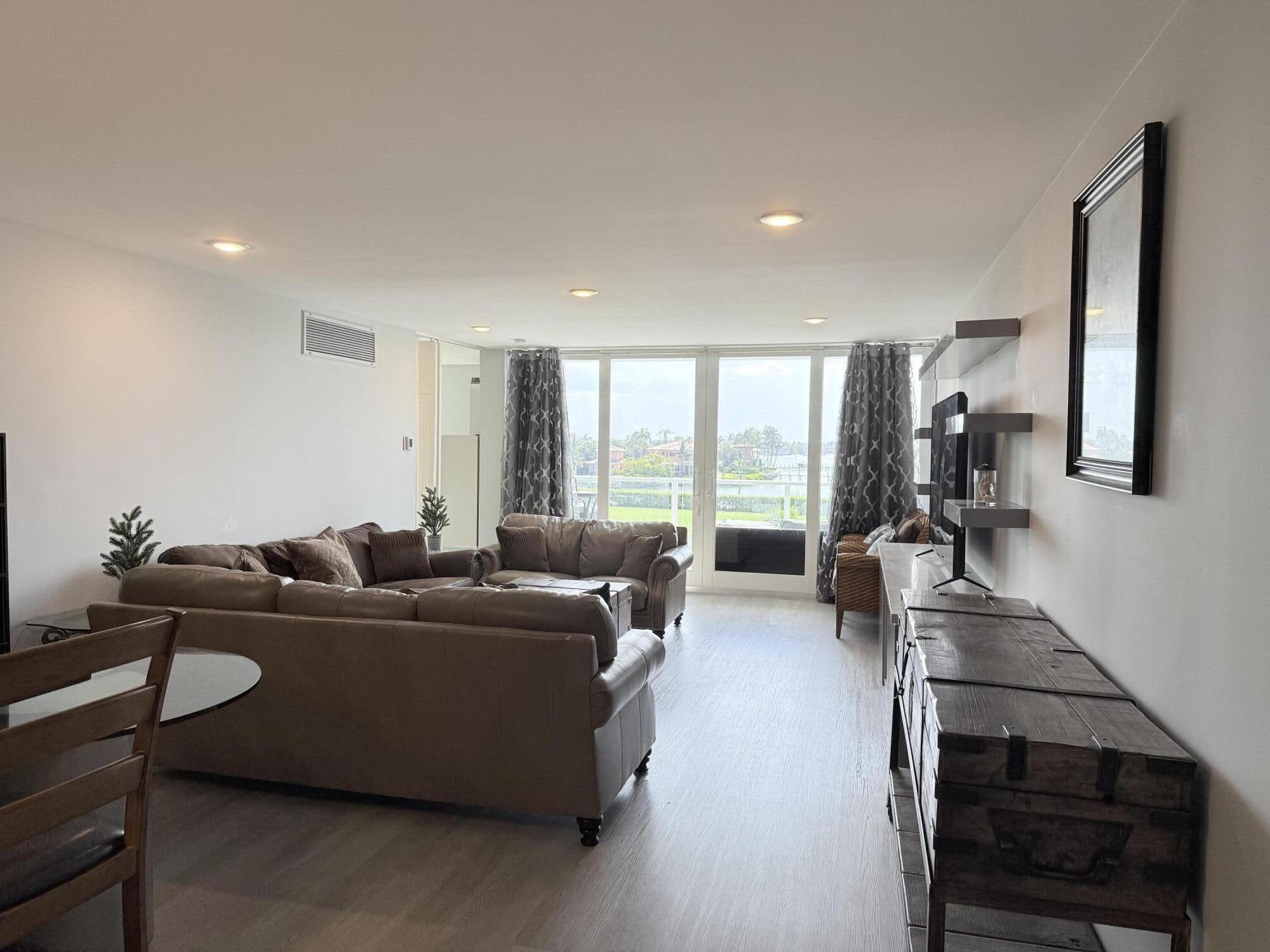 3450 South Ocean Boulevard, Unit 2220 Palm Beach, FL 33480 - Photo 2 of 36 a living room with furniture a large window and gym equipment