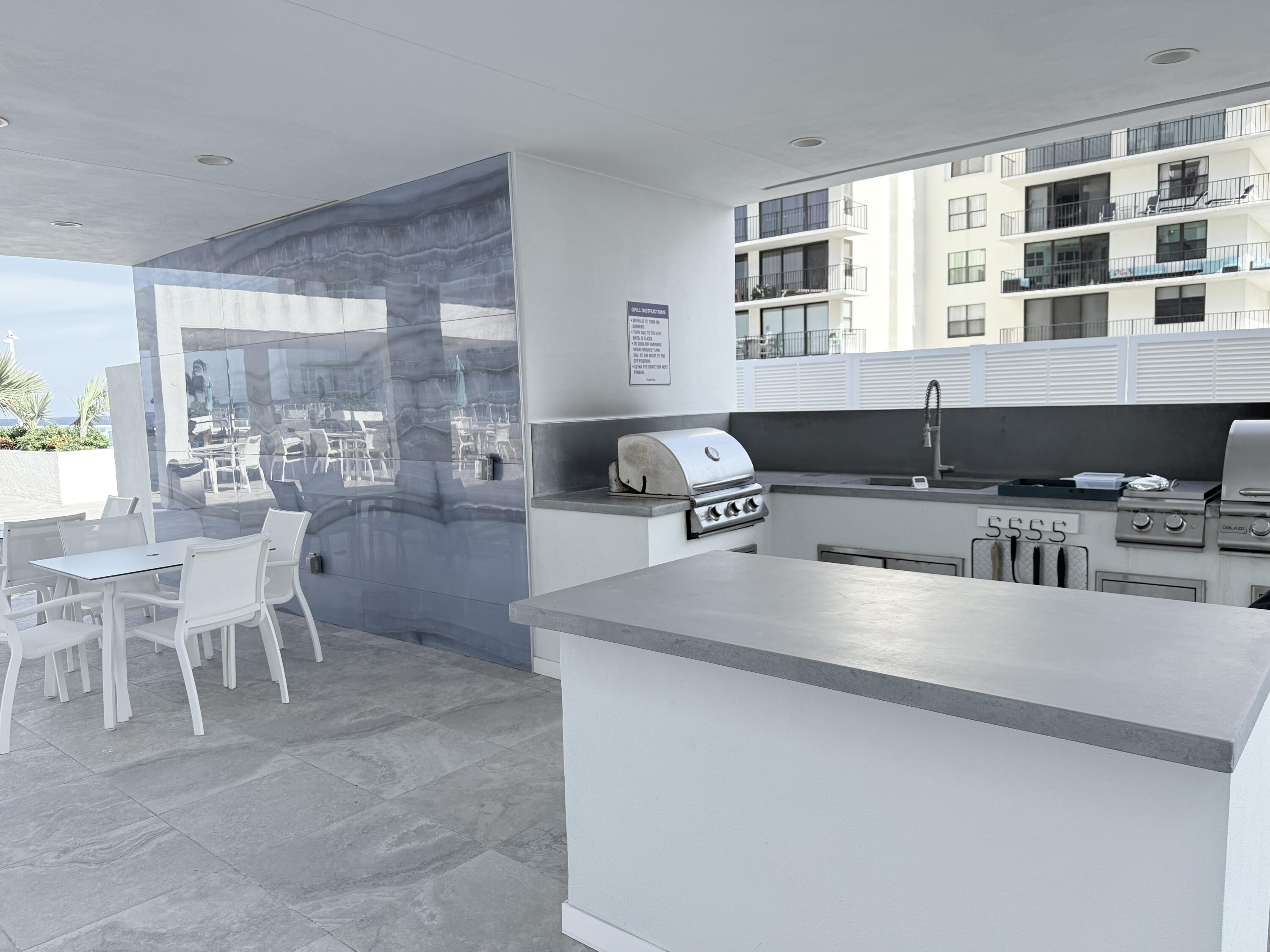 3450 South Ocean Boulevard, Unit 2220 Palm Beach, FL 33480 - Photo 31 of 36 a kitchen with stainless steel appliances granite countertop a sink and a stove