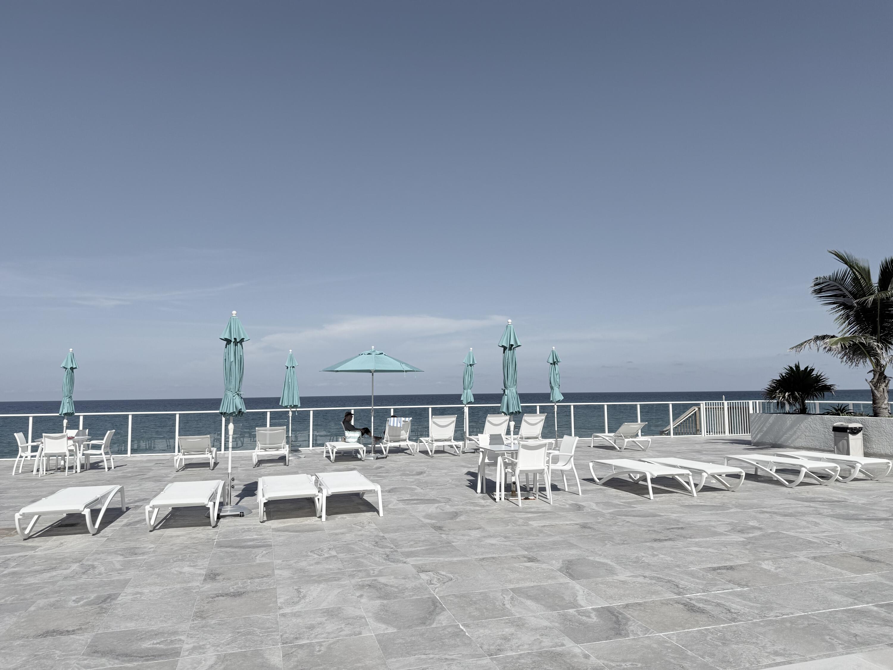 3450 South Ocean Boulevard, Unit 2220 Palm Beach, FL 33480 - Photo 32 of 36 a view of a swimming pool and outdoor seating