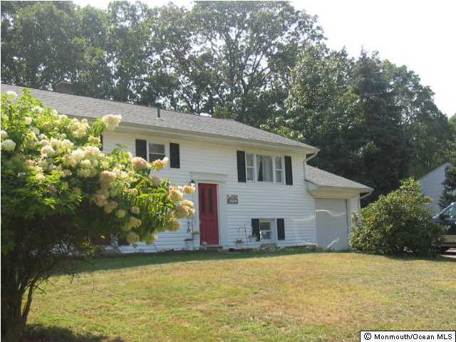122 Darien Road Howell, NJ 07731 - Photo 1 of 3 a front view of house with yard and trees around