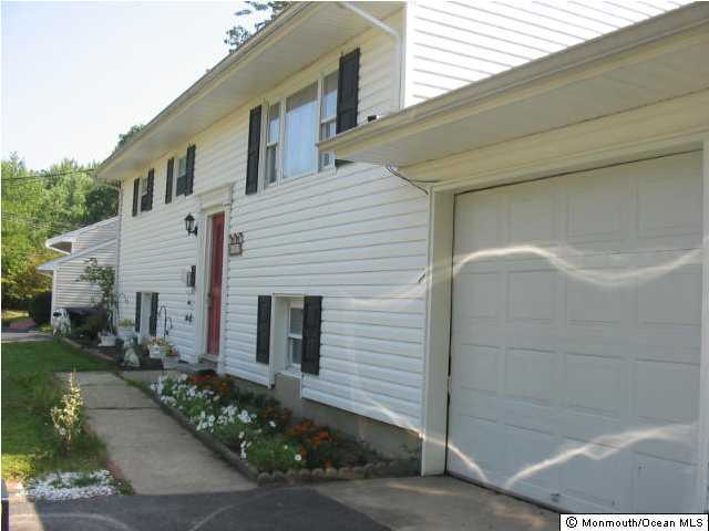 122 Darien Road Howell, NJ 07731 - Photo 2 of 3 a front view of a house with a yard