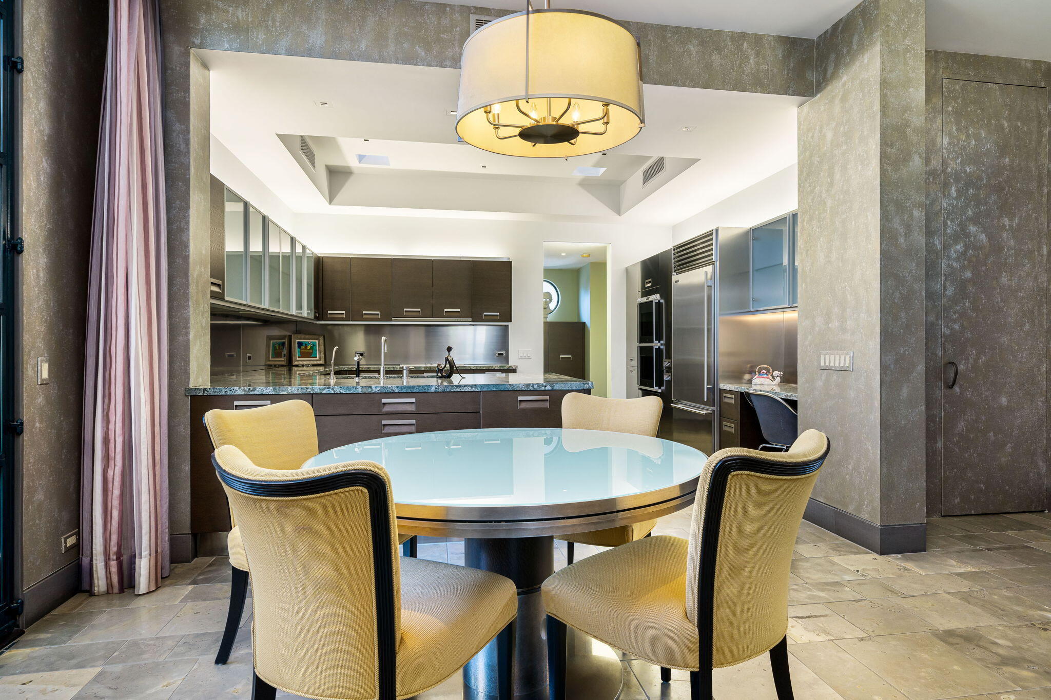 25 Sun Ridge Circle Rancho Mirage, CA 92270 - Photo 32 of 86 a view of a dining room with furniture and a chandelier