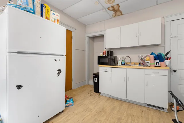 a kitchen with a refrigerator and cabinets
