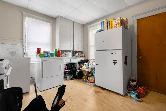 a view of kitchen with workspace and windows
