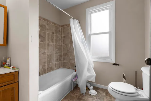 a white bath tub sitting next to a white toilet