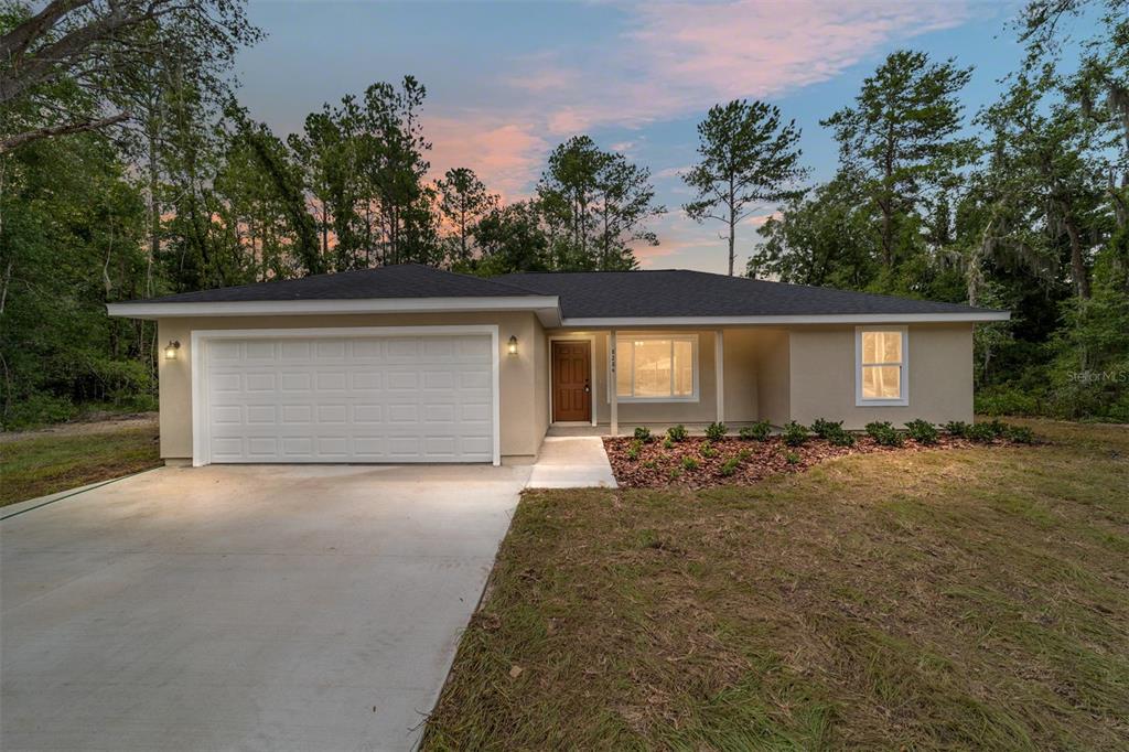 14579 Southwest 79 Terrace Road Ocala, FL 34473 - Photo 1 of 1 front view of house with a yard and trees all around