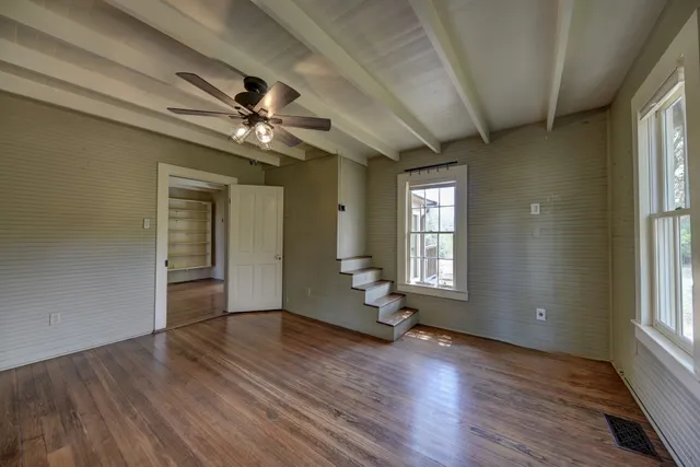 a bedroom with a large bed and a dresser