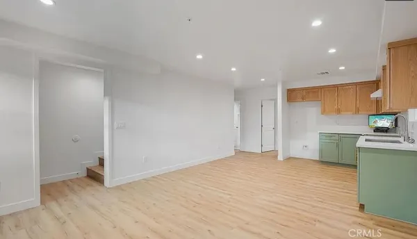 a view of a kitchen with a sink and a refrigerator