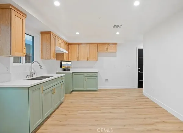 a kitchen with a sink cabinets and window