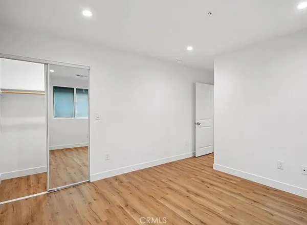 an empty room with wooden floor