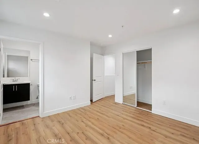 a view of empty room with wooden floor