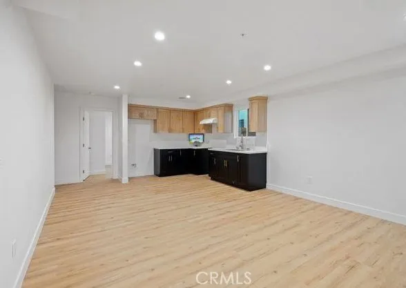 a view of kitchen and hall with wooden floor