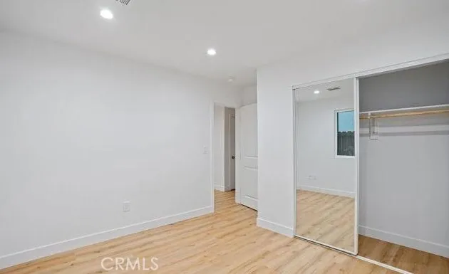a view of hallway with wooden floor
