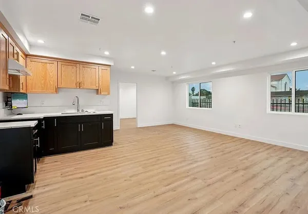 a kitchen with granite countertop a sink and cabinets