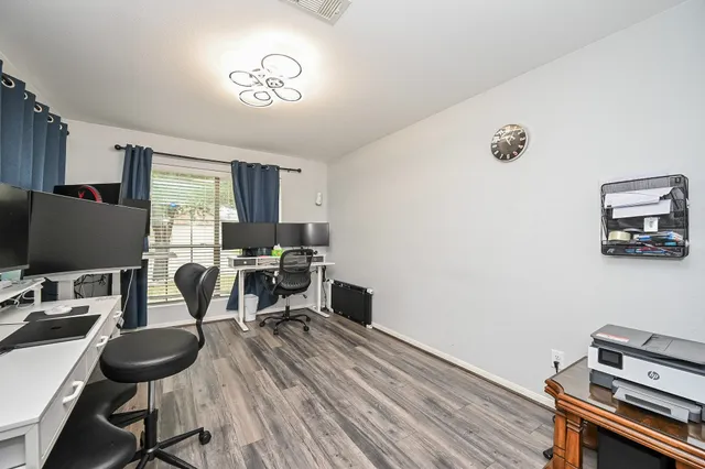 a workspace with furniture and wooden floor